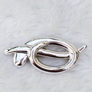 Vintage Monet silver toned knot brooch